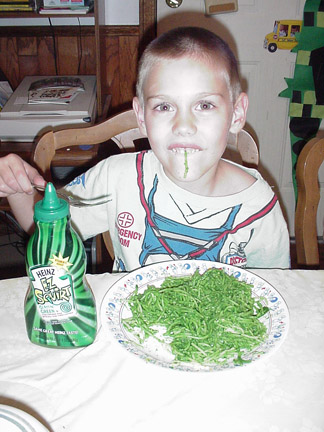He loves his green spaghetti!